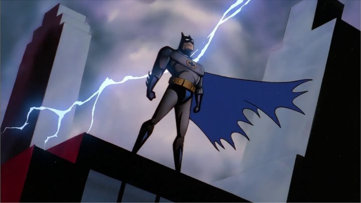 Batman standing atop a building as lightning strikes behind him in The Animated Series opening.