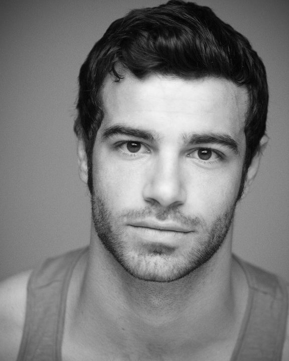 A close up of actor Ben Starr, presetned in black and white.