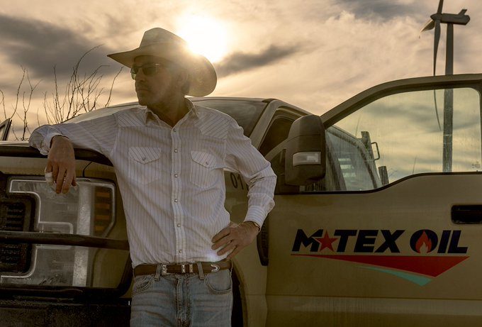 A man stands outside of his truck.