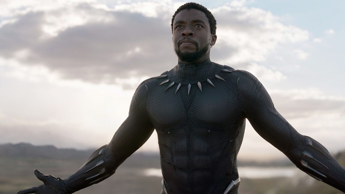 Chadwick Boseman poses with his arms out in a still from the movie Black Panther.