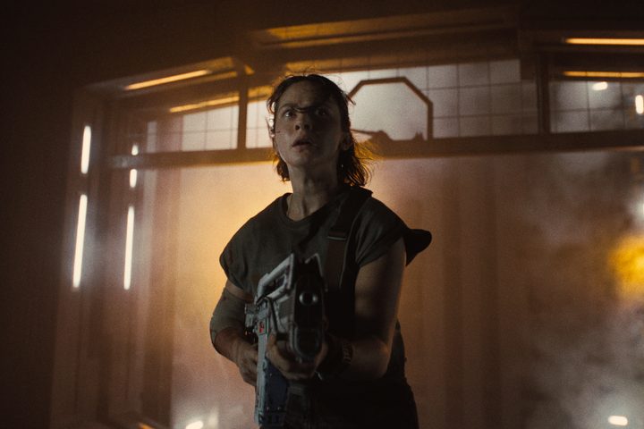 Cailee Spaeny holds a futuristic gun in Alien: Romulus.
