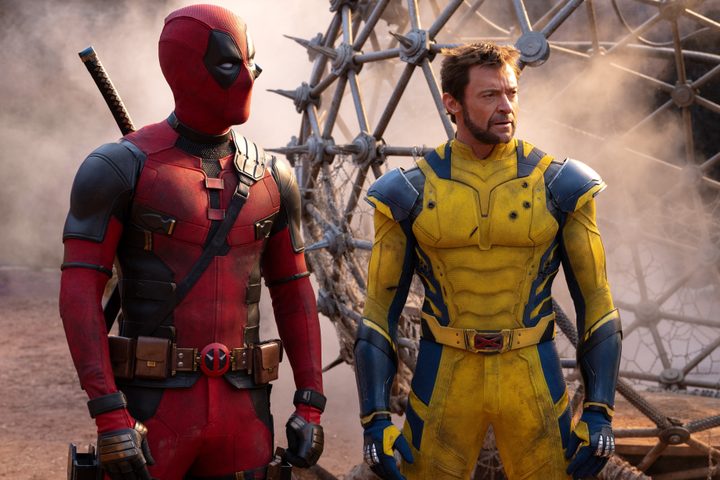 Deadpool and Wolverine stand near a metal cage in Marvel's Deadpool & Wolverine.