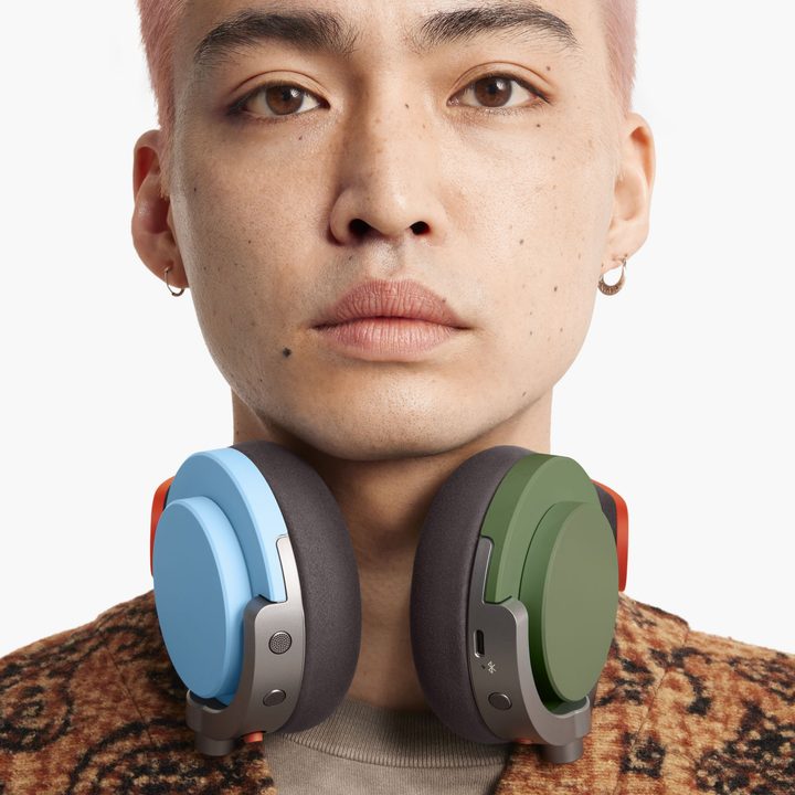 A model wearing Dyson OnTrac headphones in a customized color combo.