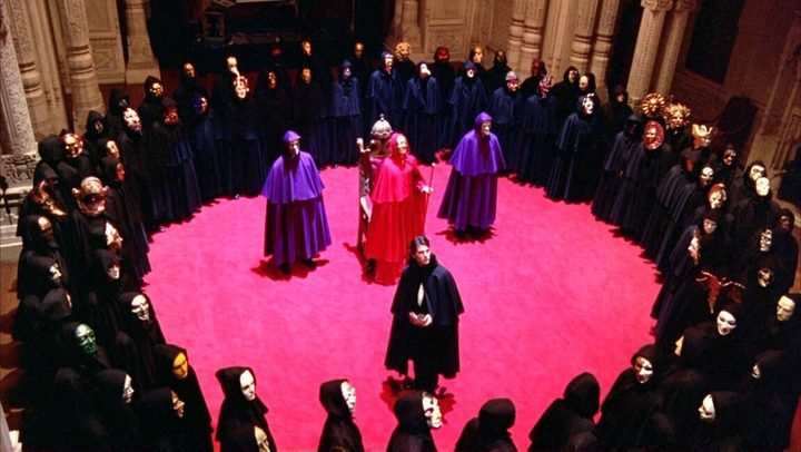 A group of people during a ceremony look up in Eyes Wide Shut.