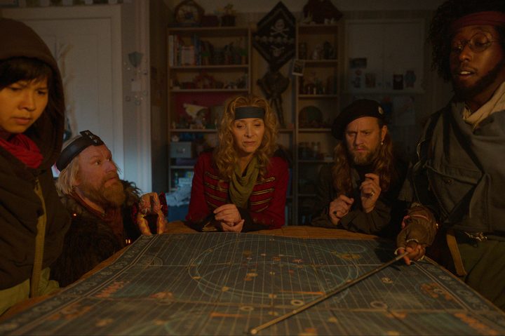 Five time travelers look at a map together in Time Bandits.