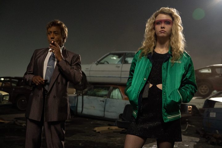 Giancarlo Esposito and Mia Goth stand in a junkyard together in MaXXXine.