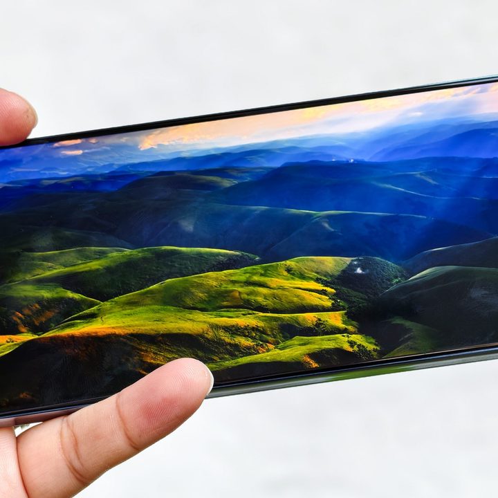AMOLED screen on the Infinix GT 20 Pro gaming phone held in hand.