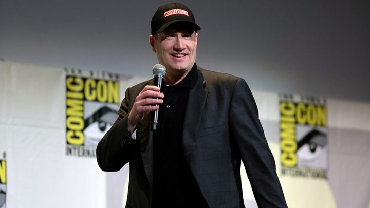 Kevin Feige holds a microphone onstage at Comic-Con.