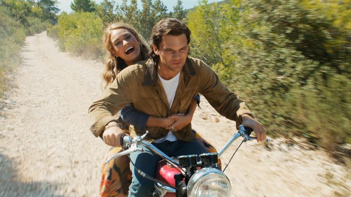 A man and a woman ride on a motorcycle in Mamma Mia 2.