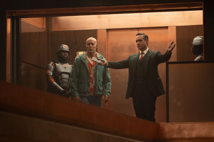 Mr. Paradox leads Wade Wilson around the TVA's headquarters in Deadpool and Wolverine.