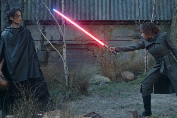 Osha points a bleeding lightsaber at Qimir in The Acolyte.