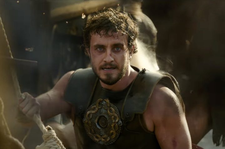 A soldier stands and stares while in the middle of battle in "Gladiator II."