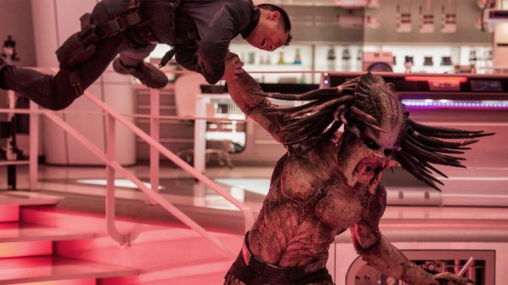 A Predator manhandles a soldier in The Predator.