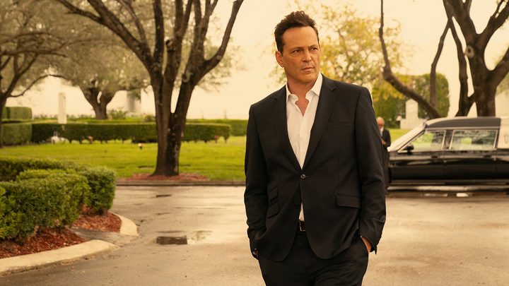 Vince Vaughn wearing a suit with his hands in his pockets looking off to the left in a scene from Bad Monkey on Apple TV+.