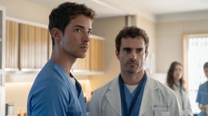 Two doctors look sternly ahead in Breathless.
