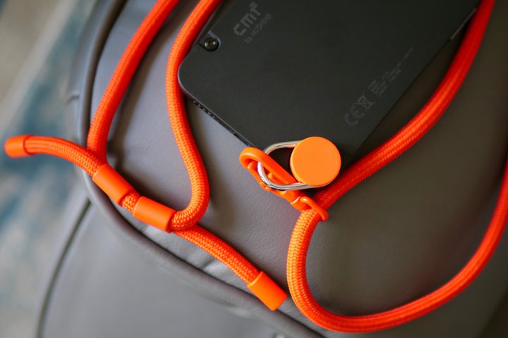 The CMF Phone 1 with a lanyard strap attached.