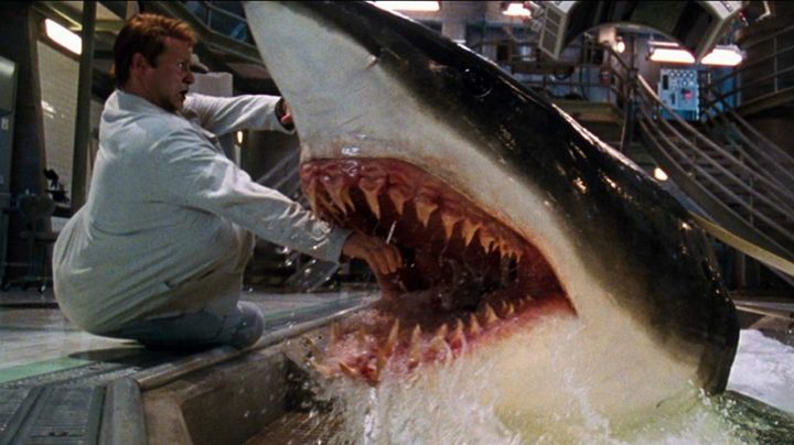 A shark attempts to bite a man in Deep Blue Sea.