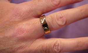 A person wearing the gold Samsung Galaxy Ring.