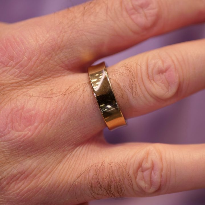 A person wearing the gold Samsung Galaxy Ring.