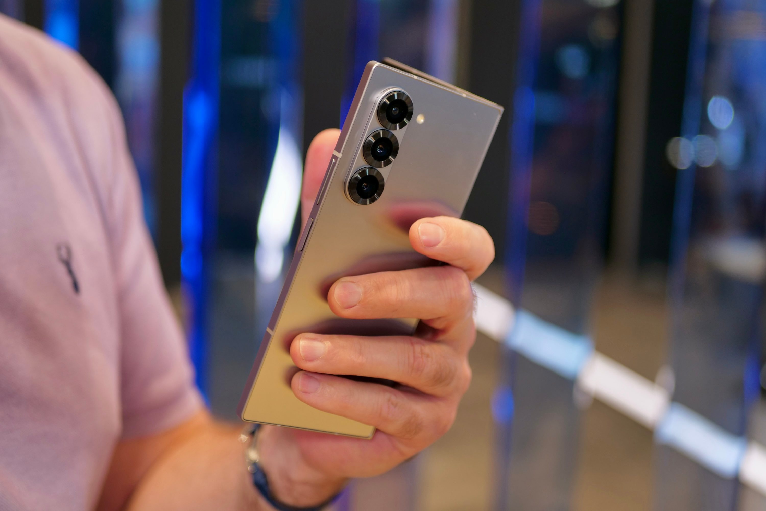 A person holding the Galaxy Z Fold 6, opening it up.