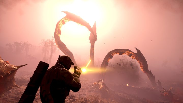 A helldiver shooting at an Impaler, which looks like giant tentacles coming out of the ground.
