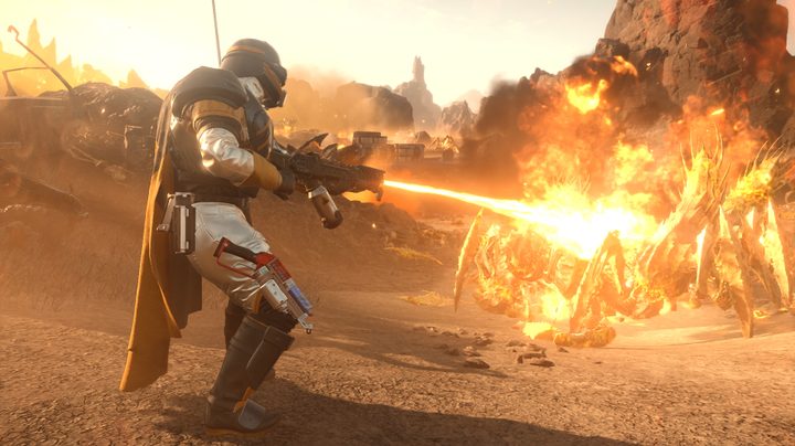 A helldiver shooting a gun at a terminid, but it's shooting fire.