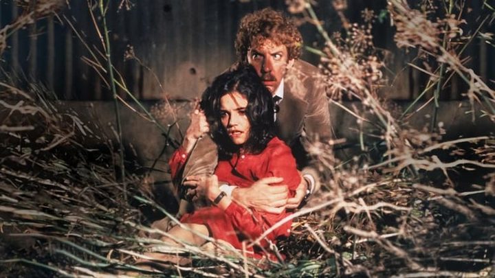 A man holds woman in Invasion of the Body Snatchers.