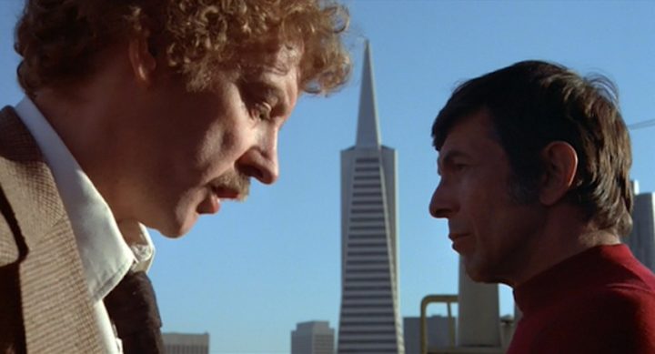 Two men look at each other in Invasion of the Body Snatchers.
