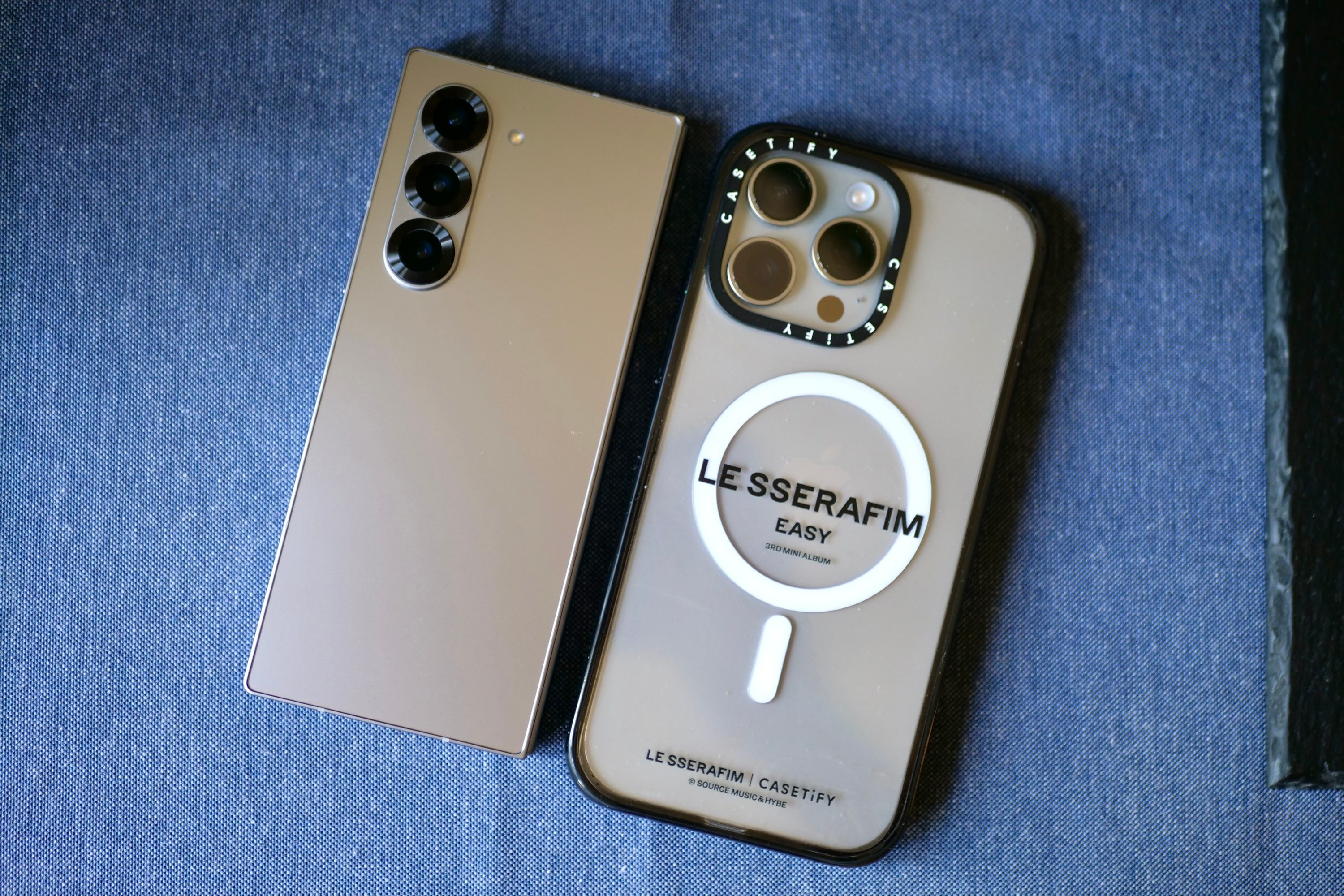 The Samsung Galaxy Z Fold 6 and the Apple iPhone 15 Pro Max, seen from the back.