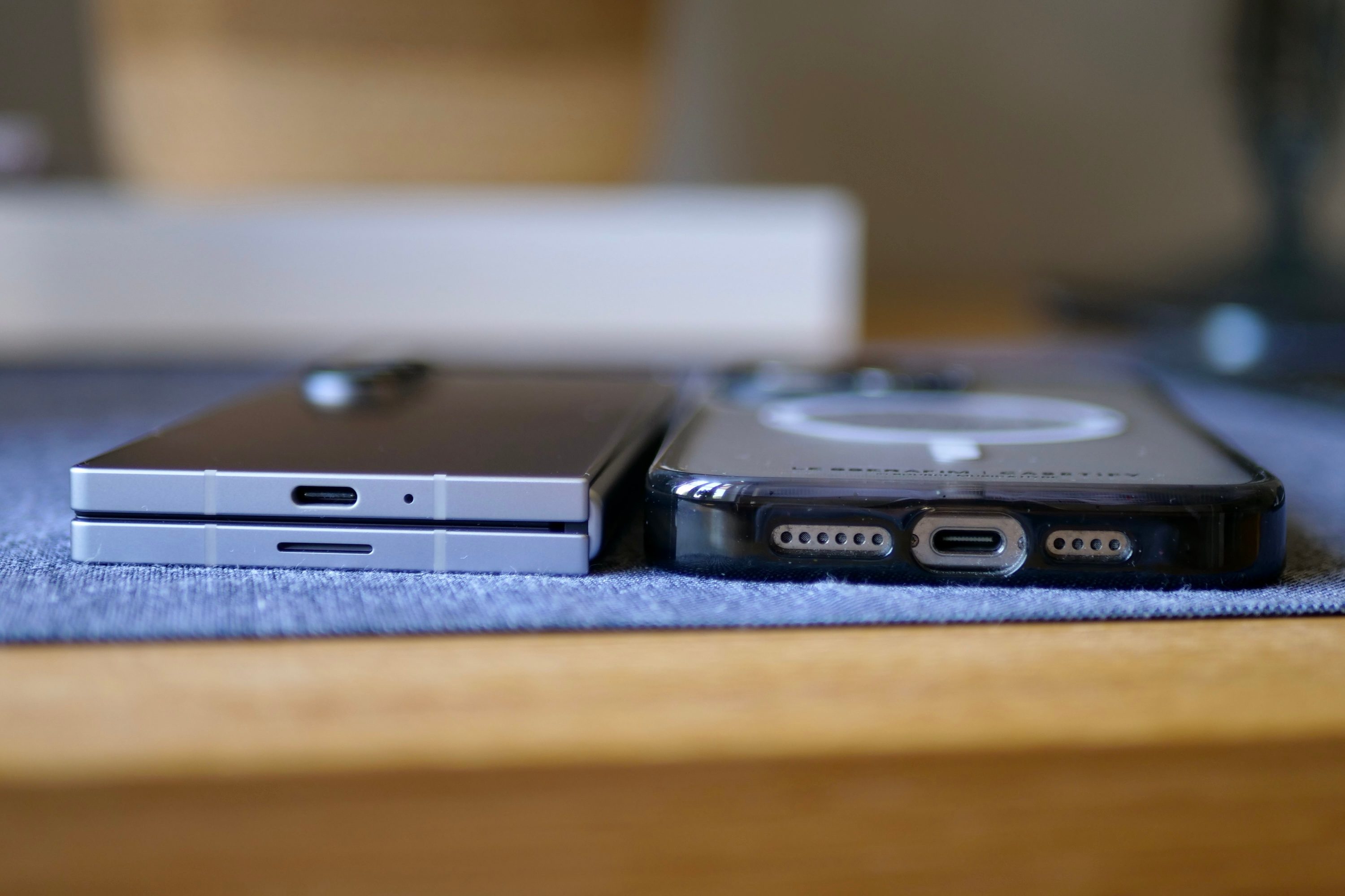 The Samsung Galaxy Z Fold 6 and the Apple iPhone 15 Pro Max, showing the difference in thickness.
