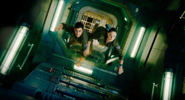 Two people float in space in Life.