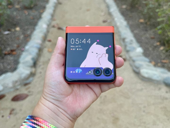 Motorola Razr 2024 in Spritz Orange held in hand showing Moo.