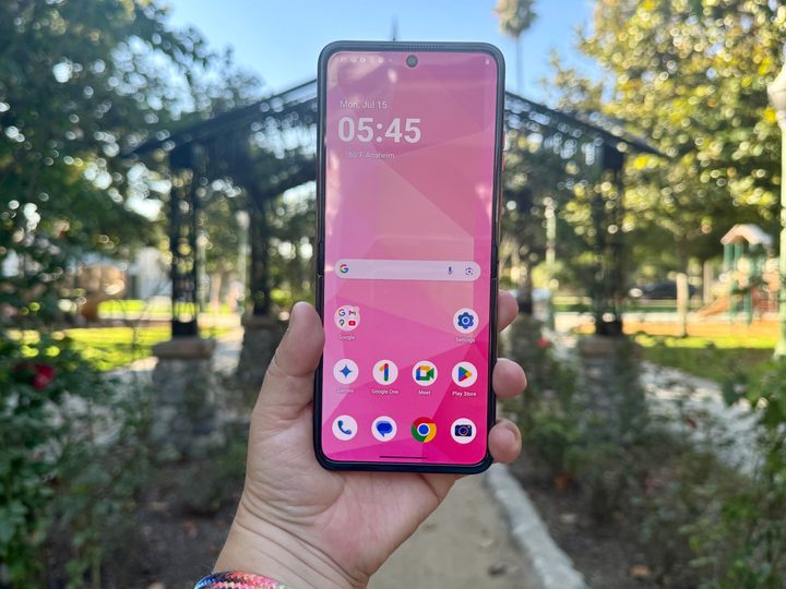 Motorola Razr 2024 in Spritz Orange showing home screen.