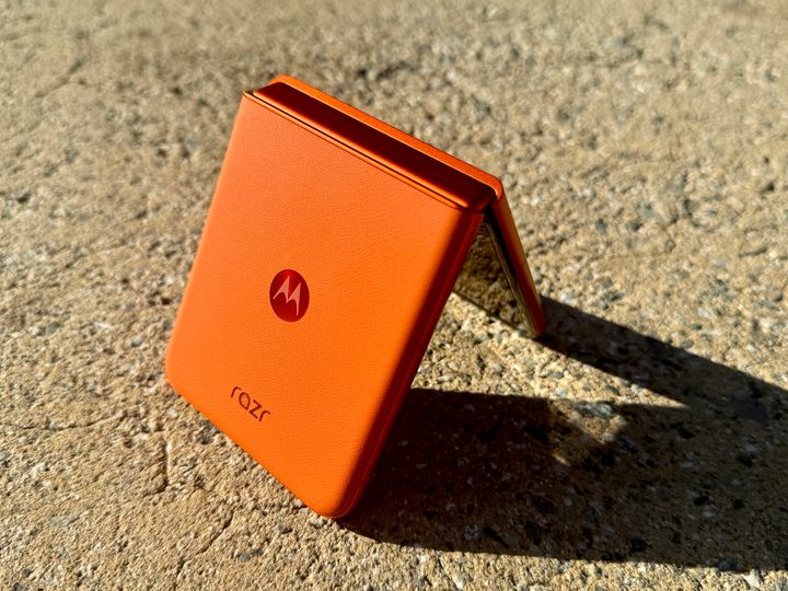 Motorola Razr 2024 in Spritz Orange propped open in tent mode.