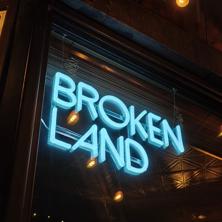 A photo of a neon sign that says "Broken Land," , taken with the Motorola Razr Plus 2024.