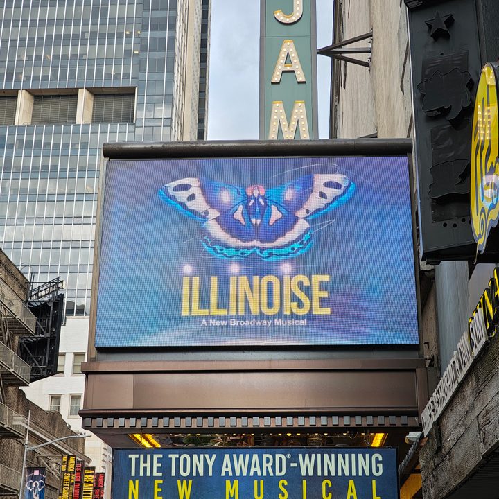 A photo of a sign for the musical Illinoise on Broadway, taken with the Motorola Razr Plus 2024.