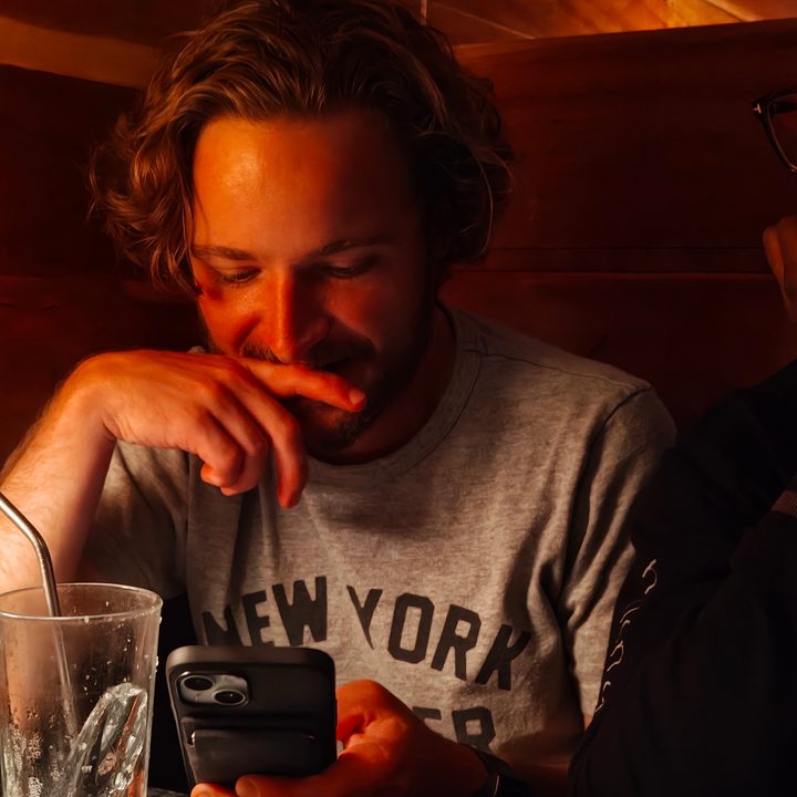 A photo of someone sitting in a dark bar, taken with the Motorola Razr Plus 2024.