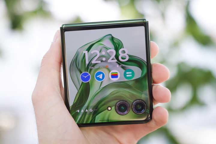 Someone holding the Motorola Razr Plus 2024, showing its cover screen.