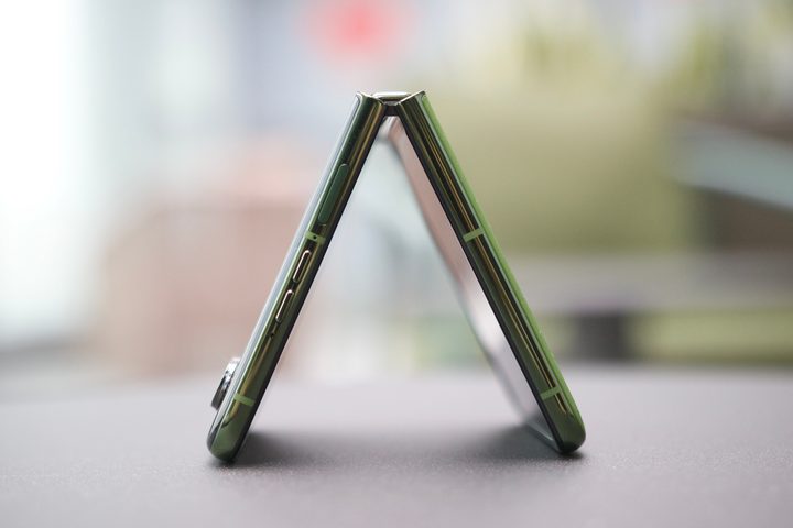 A side view of the Motorola Razr Plus 2024, showing the phone half-folded.