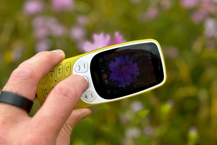 A person taking a photo with the Nokia 3210.