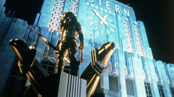 A Predator stands on a building in Predator 2.
