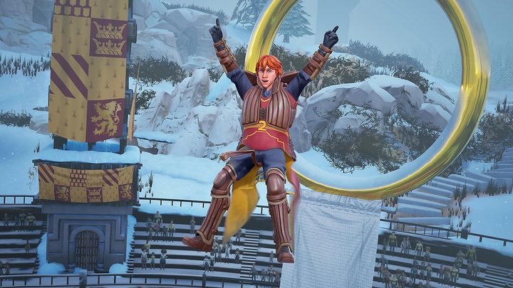 Ron Weasley (or another redhead that looks like Ron) flying on his broom in front of a goal with his arms raised.