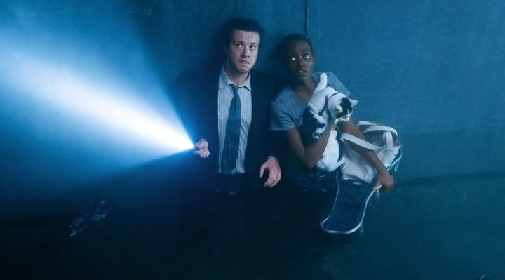Two people huddle in darkness in A Quiet Place: Day One.