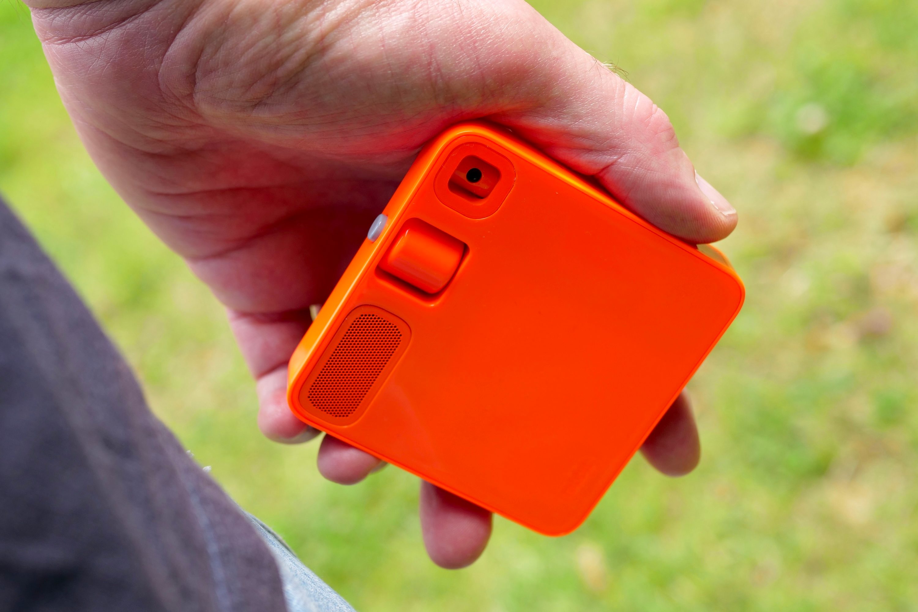 A person holding the Rabbit R1.