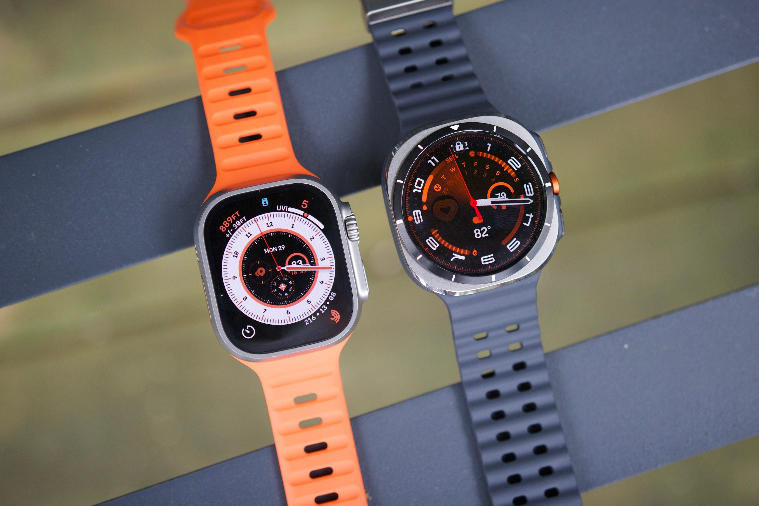 The Samsung Galaxy Watch Ultra and Apple Watch Ultra 2 sitting next to each other.
