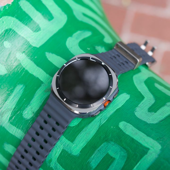 The Samsung Galaxy Watch Ultra laying on an green sculpture.