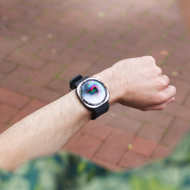 Someone wearing and looking at a Samsung Galaxy Watch Ultra.