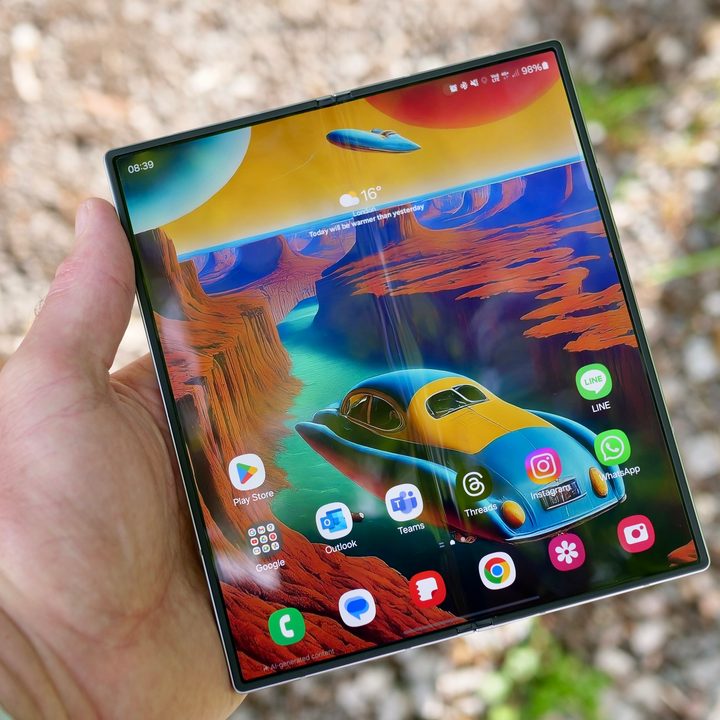 A person holding the open Samsung Galaxy Z Fold 6.