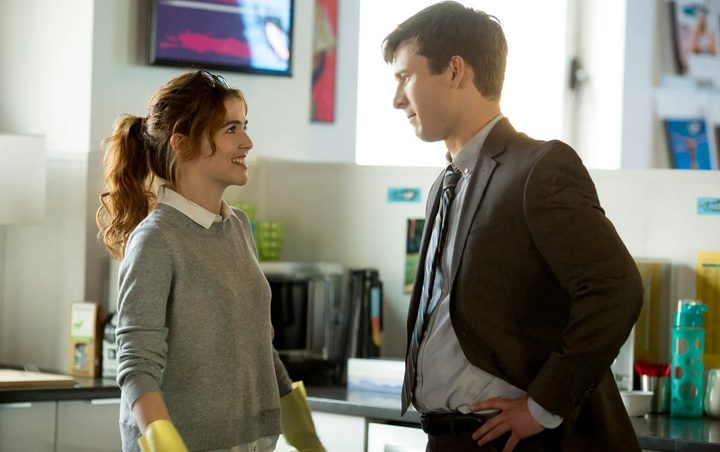 A man and a woman look at each other in Set It Up.