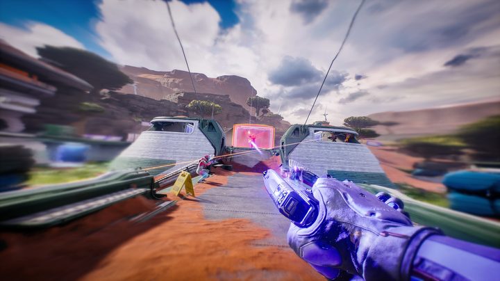 A person sliding while shooting a pistol.